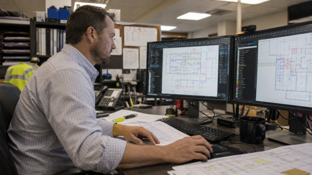 Estimator confidently working in Bluebeam Revu at a desk with a workflow-specific Tool Set open.